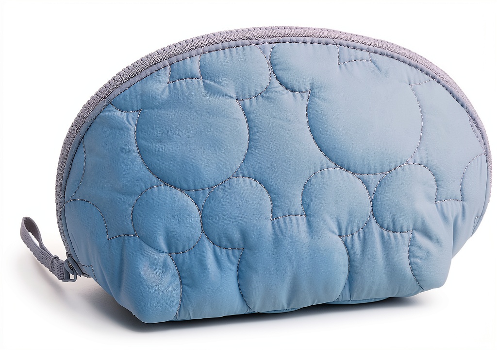 'Vera Bradley featherweight cosmetic bag in Super Sonic color on a table'